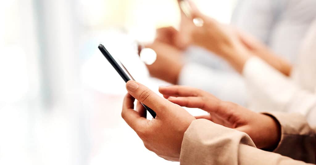 line of people holding phones evoking company iPhone update