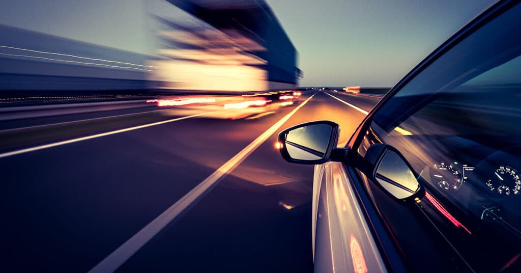 car speeding down road evoking driver safety program