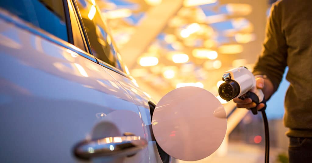 man charging his electric car evoking ev rates