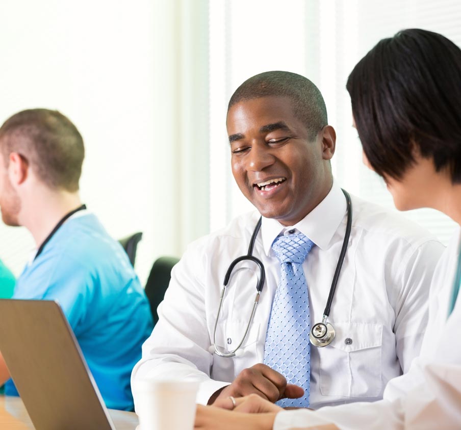 Man with a stethoscope laughing