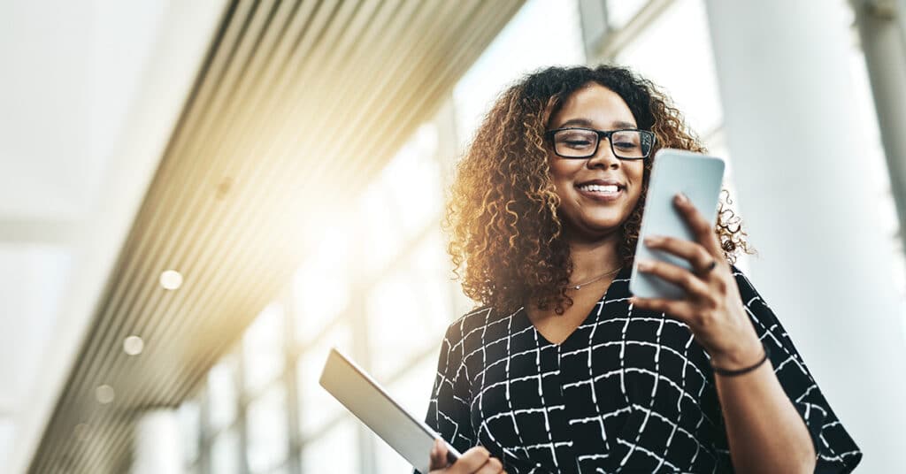 business woman with phone evoking how to choose an MMS provider