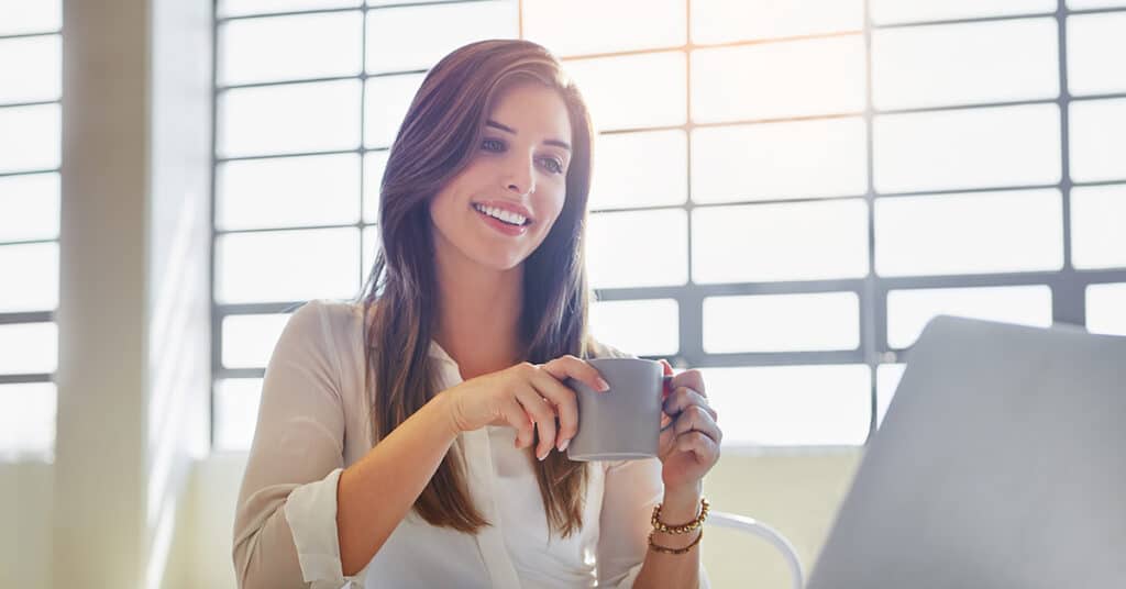 business woman in front of laptop evoking HR leaders Leverage Automation
