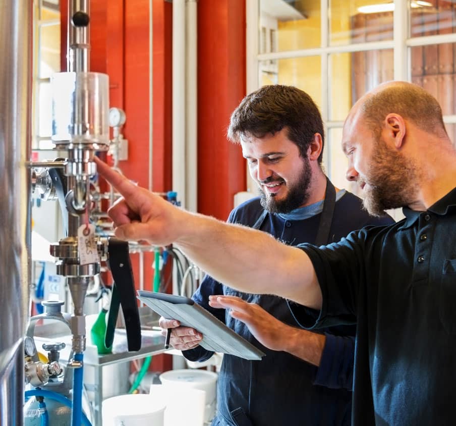 Two men working at a mobile technology workplace