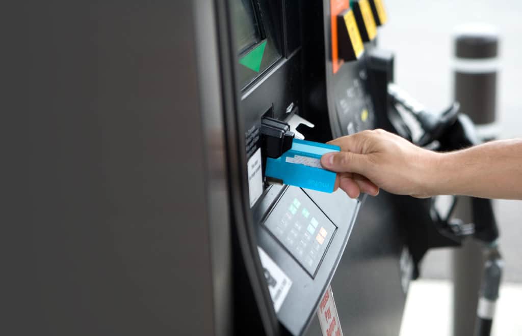 Hand inserting a card into a card reader