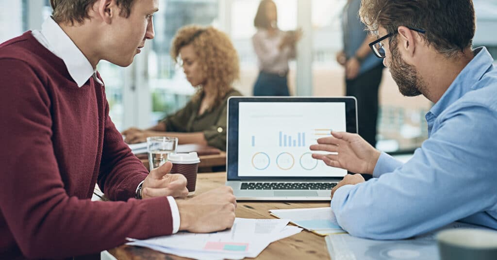 image of business people looking at screen with graphs evoking Motus insights