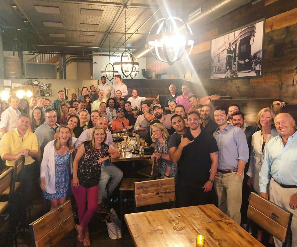 Large group of people gathered around tables