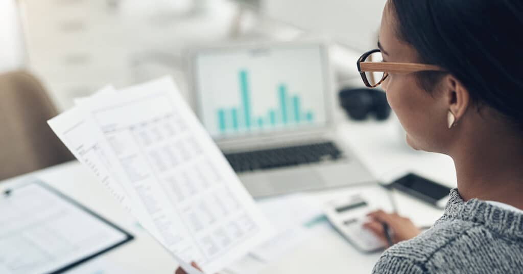 image of woman with spreadsheets evoking corporate expense management