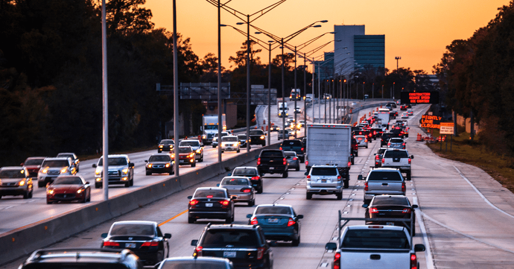 vehicles driving down highway evoking cost of mileage reimbursement