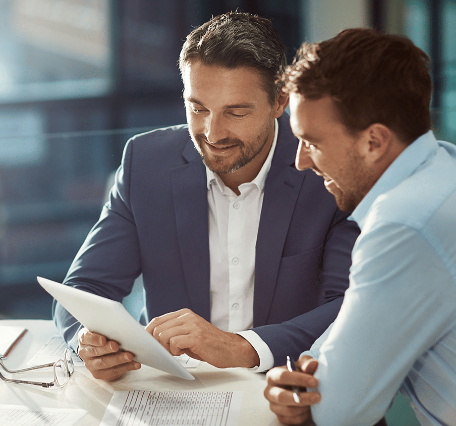 Two men looking at a tablet screen