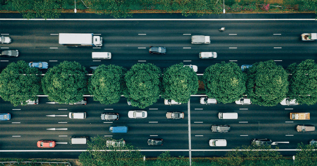 overhead shot of vehicles driving on multi lane street evoking environmental compliance