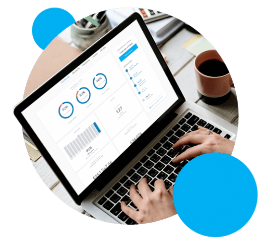 Open laptop with hands typing and graphs of data on the screen