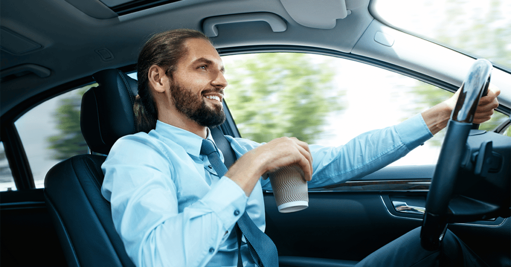 image of man in business attire at the wheel of a car evoking What is the National Average for Mileage Reimbursement?